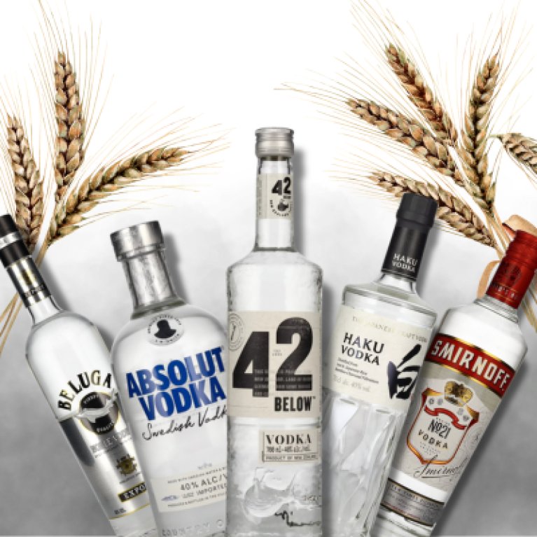 Vodka bottles of various brands stand upright, surrounded by ears of corn on a neutral background.