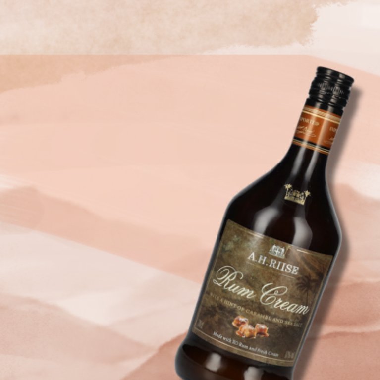Dark glass bottle with creamy caramel liqueur, photographed on a light background