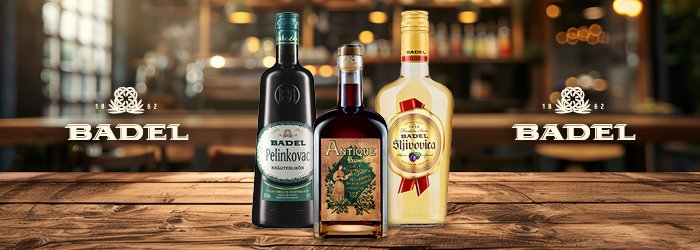 Three Badel bottles stand on a wooden table; bar background, bright and inviting.