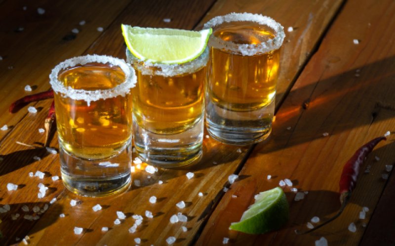The picture shows a group of glasses filled with different liquids. These include various types of drinks, both alcoholic and non-alcoholic, which are presented in different glasses.